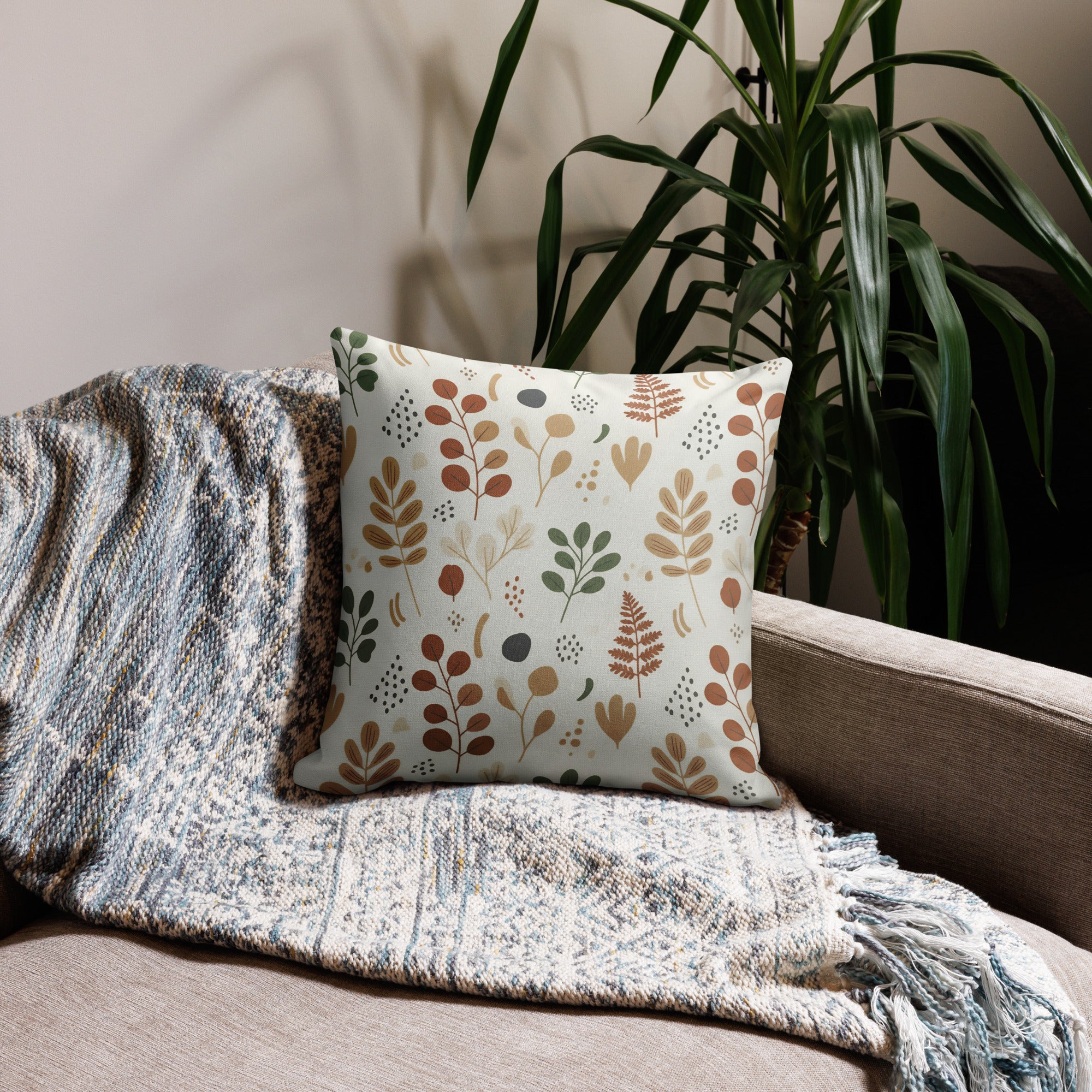Nordic botanical throw pillow with eucalyptus and fern pattern on modern beige sofa - Scandinavian home decor