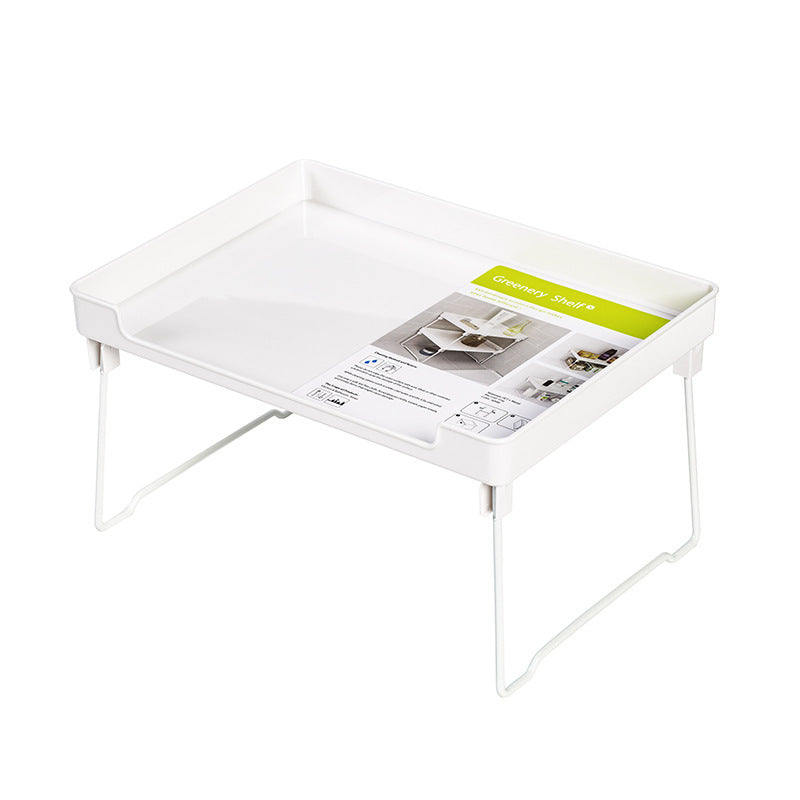 White baby changing table with a green label on a white background