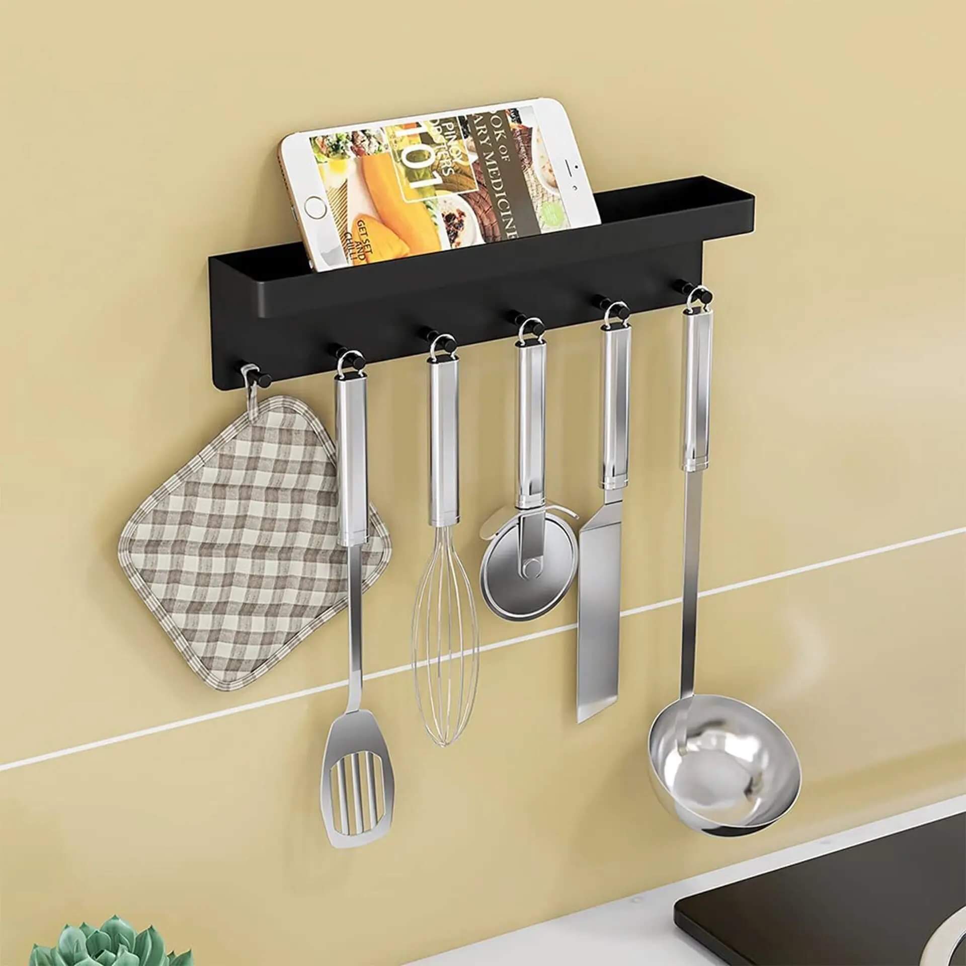 Wall-mounted stainless steel key holder in kitchen
